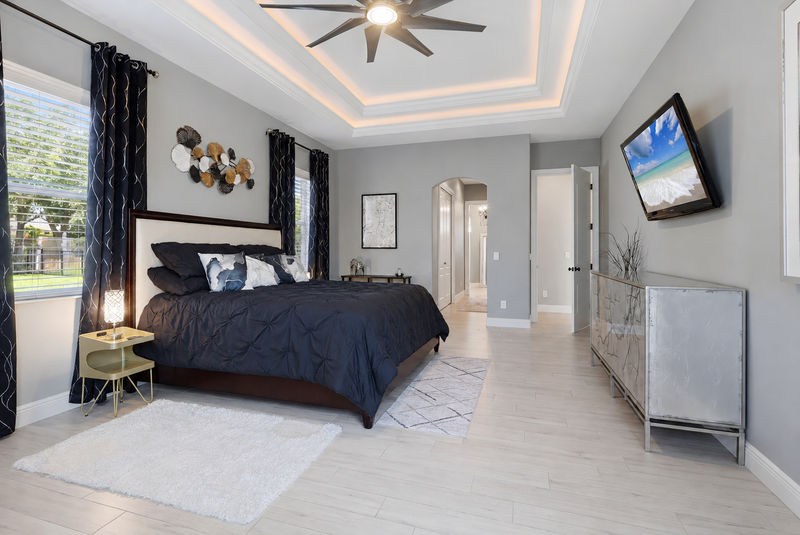 Large primary bedroom with king bed, en suite, lanai access, and  55-inch Roku TV