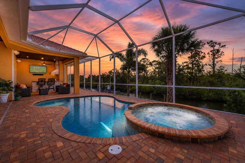 Sparkling private saltwater pool & spa overlooking water. Lanai features remote controlled privacy screens. Pool size is 17'L x 10'W x 6'D