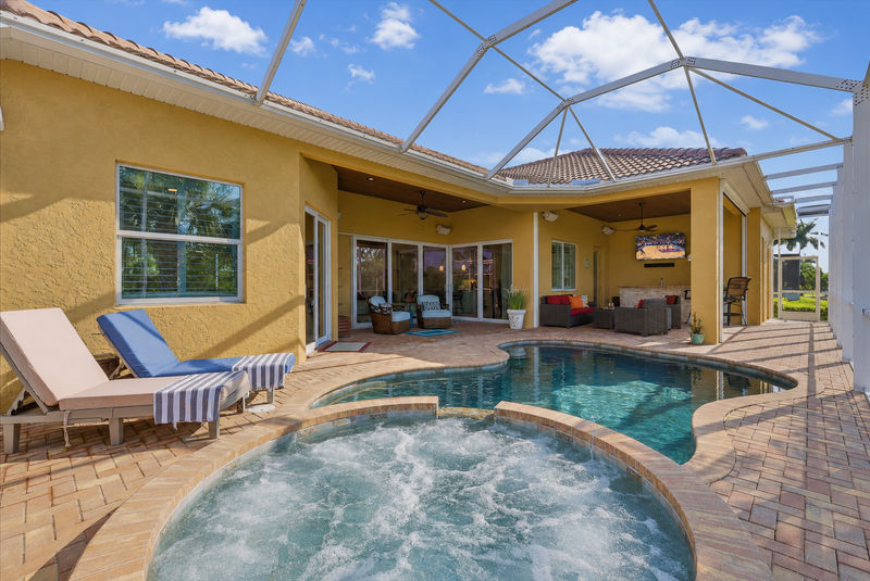 Sparkling private saltwater pool & spa overlooking water. Lanai features remote controlled privacy screens. Pool size is 17'L x 10'W x 6'D