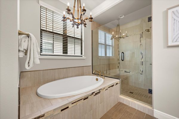 En-suite bathroom with large soaking tub and glass door walk-in shower