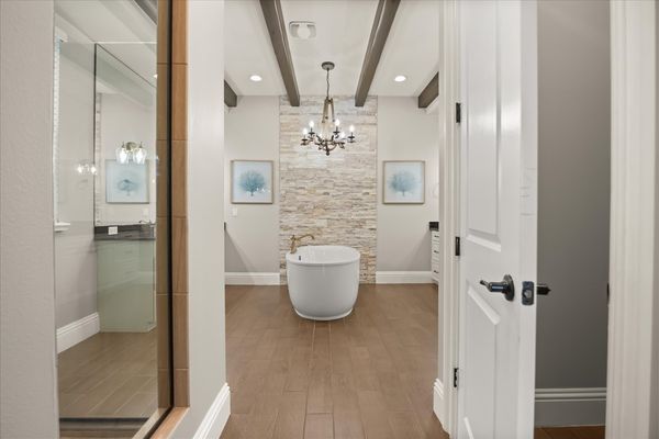 En-suite bathroom with large soaking tub and glass door walk-in shower