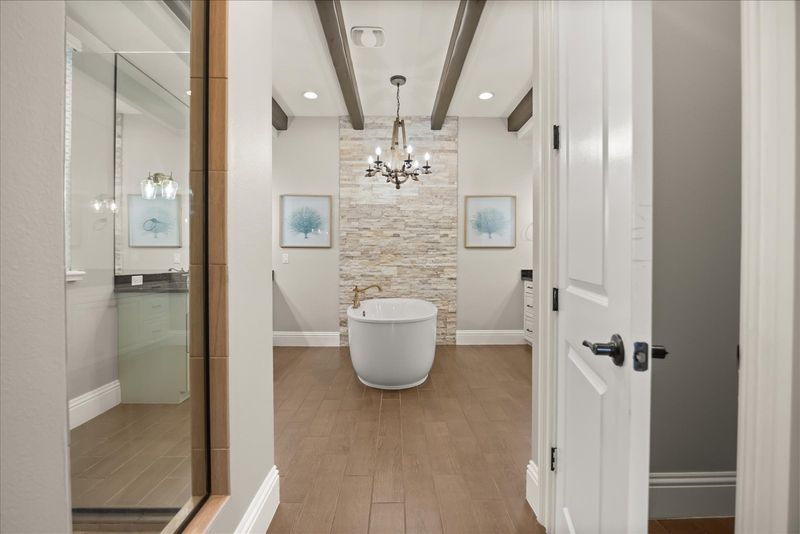En-suite bathroom with large soaking tub and glass door walk-in shower