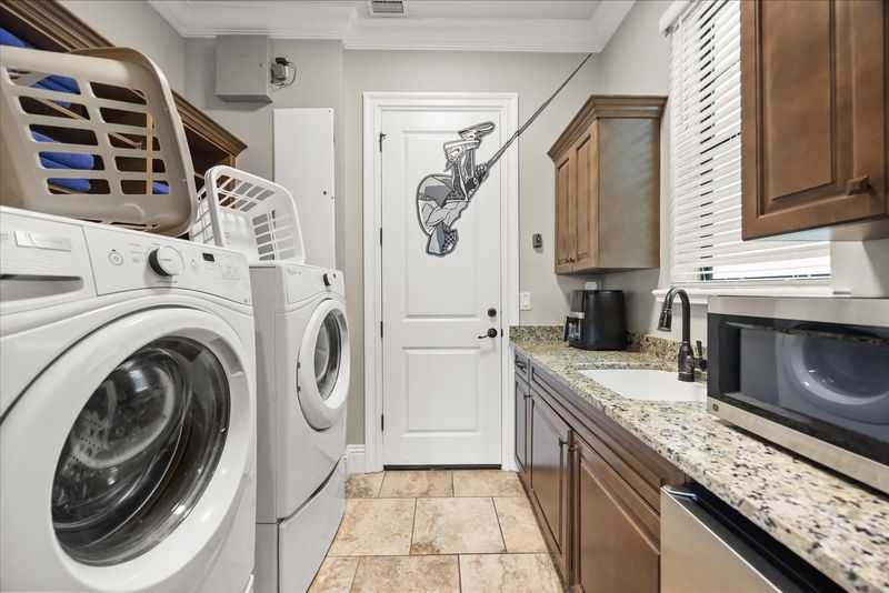 The first floor laundry room includes a washer and a dryer