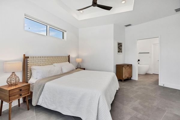 Primary bedroom with king bed, lanai Access, en suite, and 40-inch Smart TV