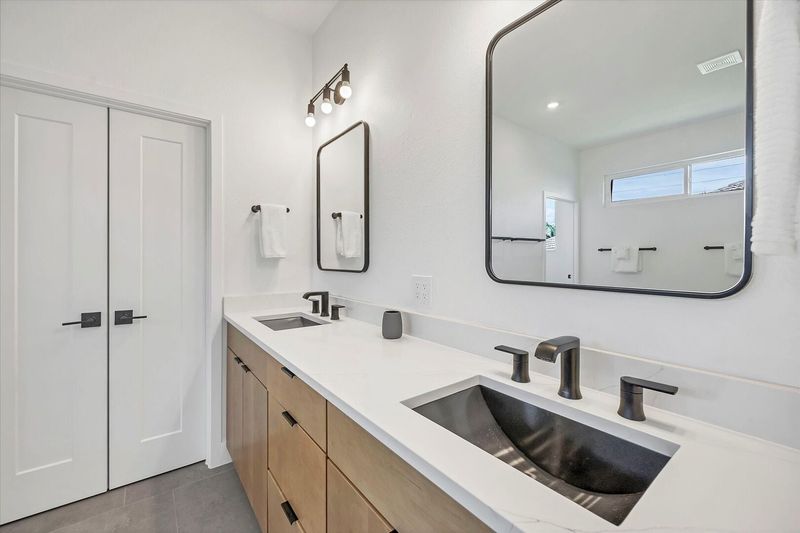 En suite with large walk-in shower, double vanities and soaking tub
