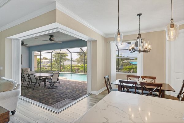 Kitchen and dining area overlooking the sparkling pool and canal