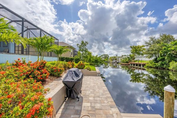BBQ grill in backyard with path leading to boat dock and canal (Boat lift not available)