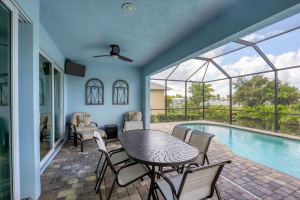 Gorgeous, large lanai with sparkling pool overlooking the canal. Lanai also features a dining table for 6 and 32-inch Smart TV. Pool size: 22' x 8' x 6'D