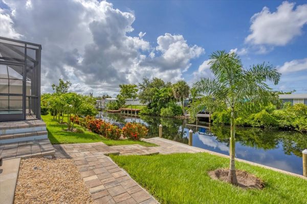 Backyard with path leading to boat dock and canal (Boat lift not available)