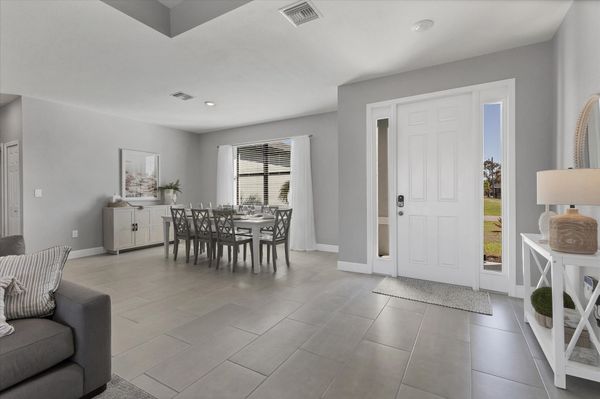 Beautiful, bright, open living area. Dining table seats 8