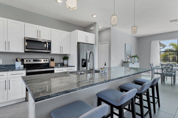 Fully equipped kitchen overlooking living room and dining area