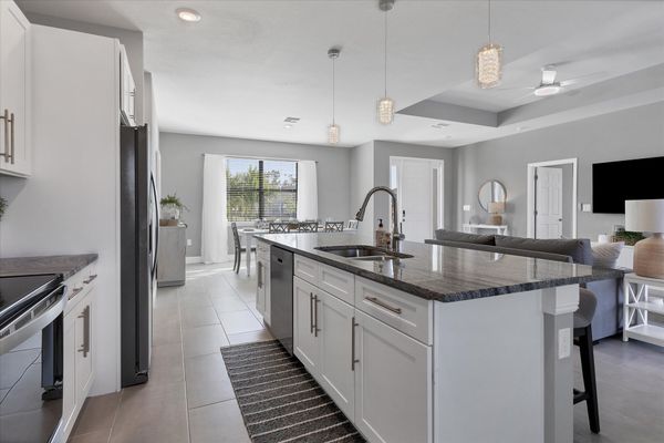 Fully equipped kitchen overlooking living room and dining area