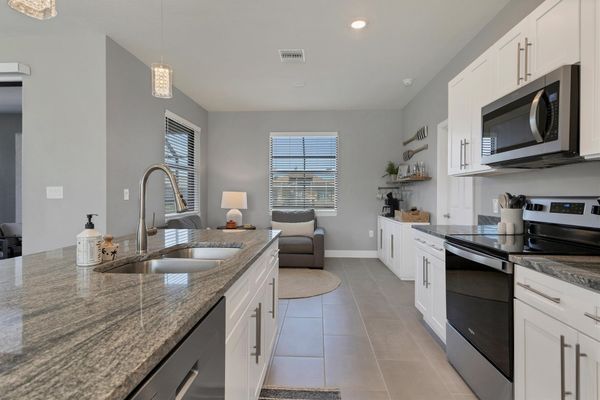 Fully equipped kitchen overlooking living room and dining area