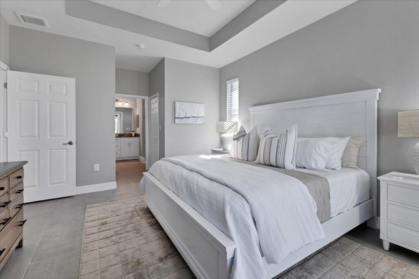 Primary bedroom with attached bathroom, lanai access, king bed and 43" Smart TV