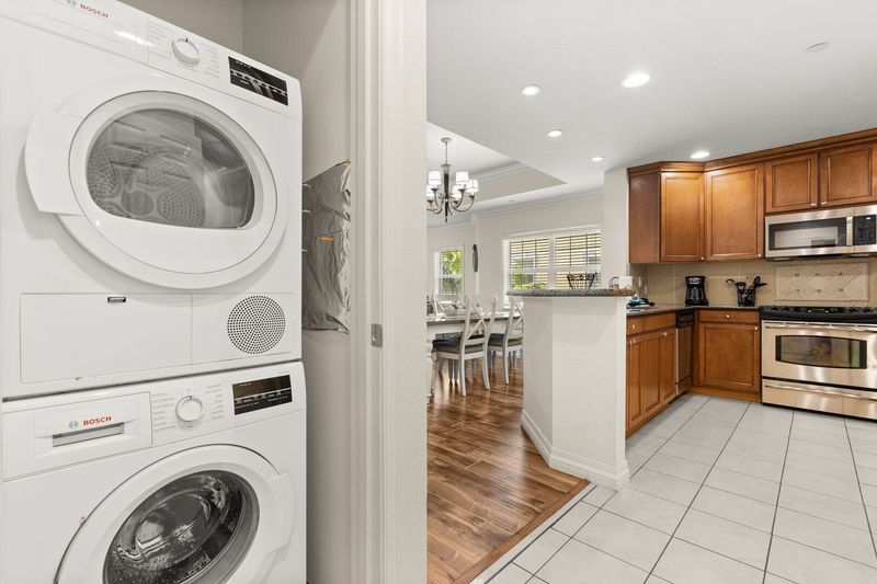 The ground floor laundry area has a washer and dryer