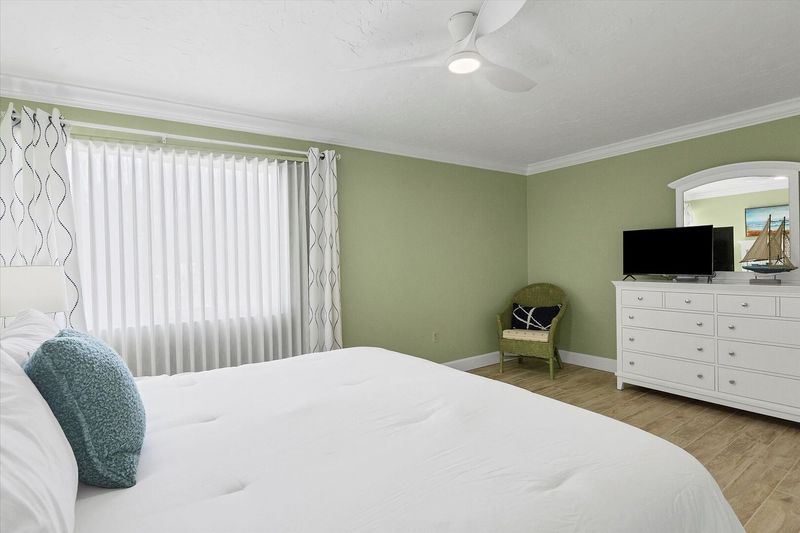Primary bedroom with king bed and 32-inch Smart TV