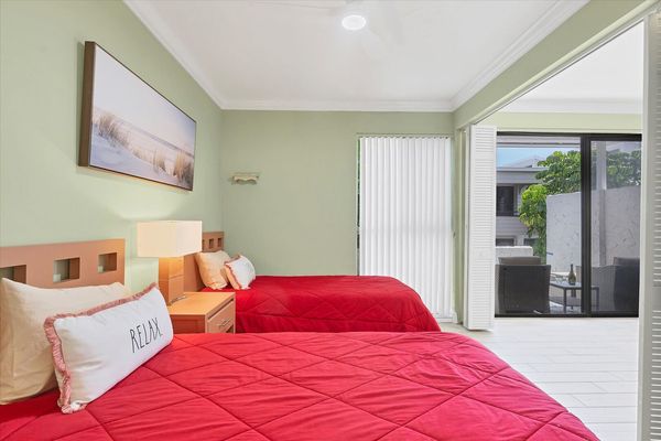 Guest bedroom features 2 twin beds, 32-inch Smart TV and attached bathroom