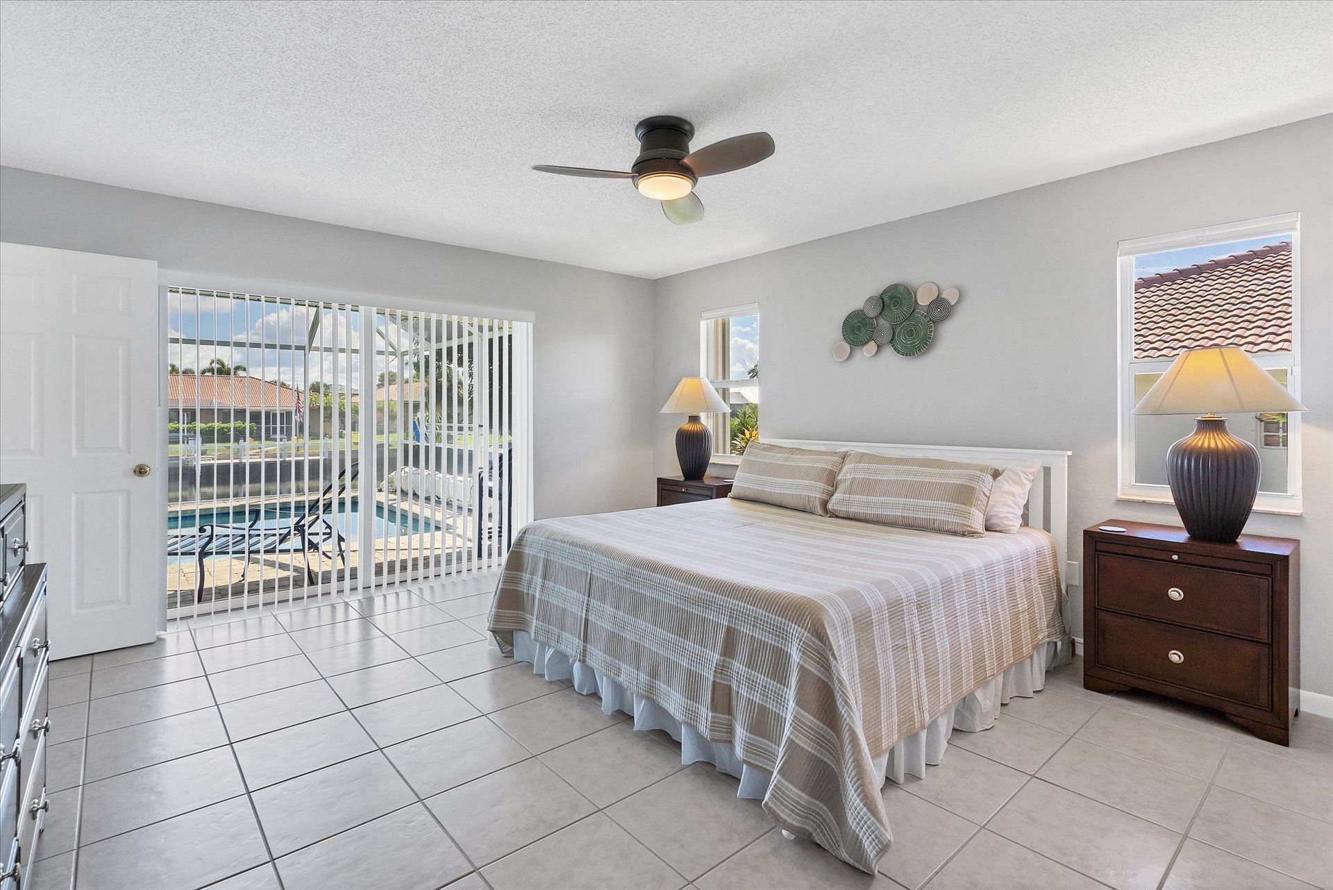 Primary bedroom with king bed, attached bathroom and lanai access