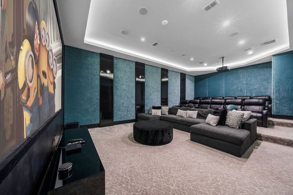 Theatre with 12 Black Leather electric reclining seats and oversized deep lush fabric sectional