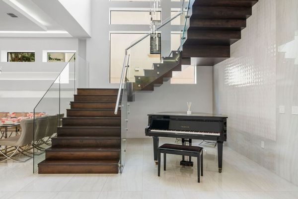 Yamaha Piano Beneath Modern Staircase