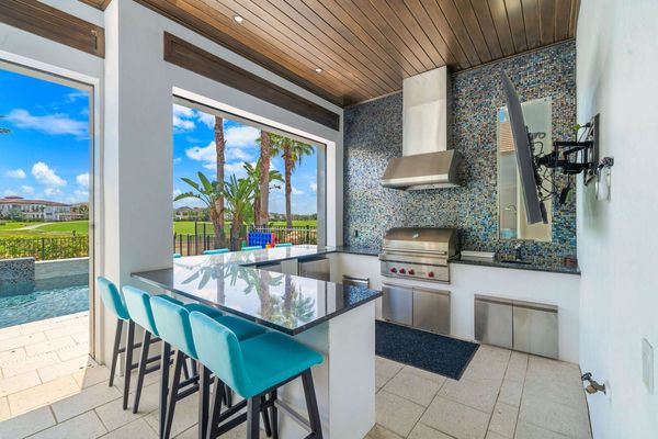 Outdoor Kitchen with Wolf Gas Grill, Refrigerator, Ice maker, and 75 inch TV