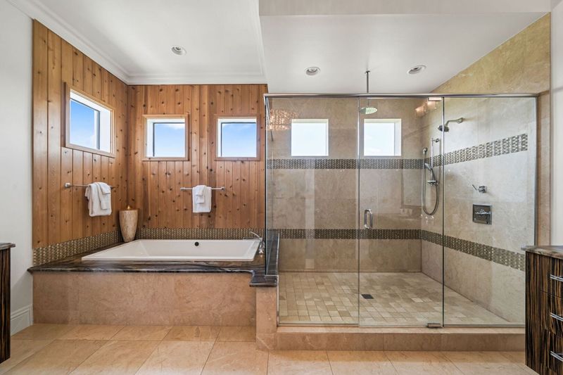 This ensuite bathroom features a garden tub and a walk-in shower