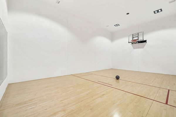 Retractable basketball net so squash and other games can be used