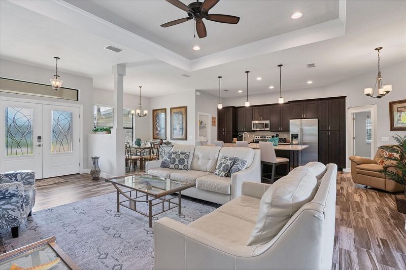 Beautiful open living space overlooking private pool & spa. Living room features comfy seating and 55-inch Smart TV