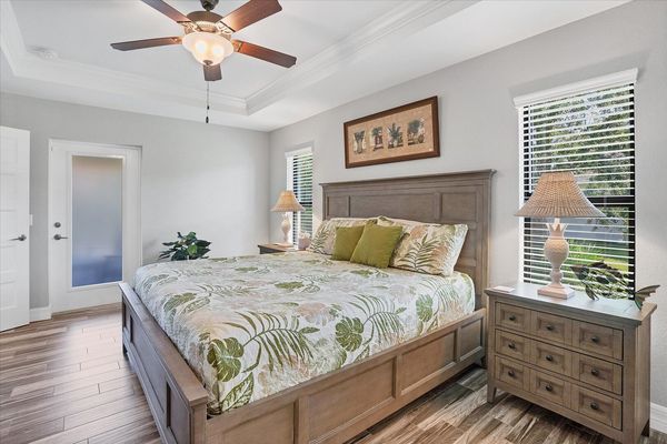 Primary bedroom with lanai access, attached bathroom and 32-inch Smart TV