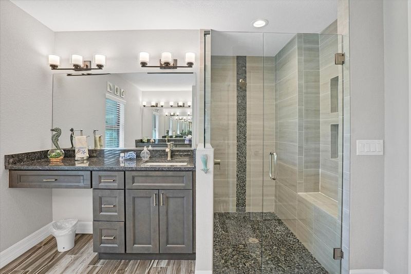 Beautiful primary bathroom with walin shower and double vanities