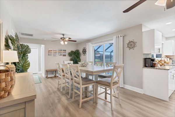 Dining room with additional refrigerator and lanai aceess. Dining table seats 10