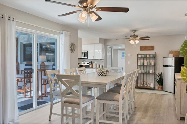 Dining room with additional refrigerator and lanai aceess. Dining table seats 10