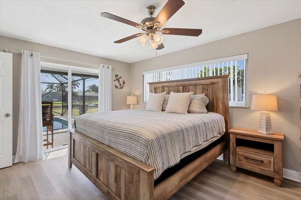 Primary bedroom with king bed, attached bathroom, and 50-inch Smart TV