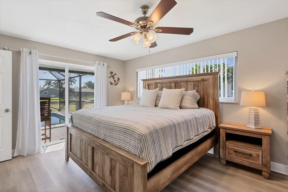Primary bedroom with king bed, attached bathroom, and 50-inch Smart TV