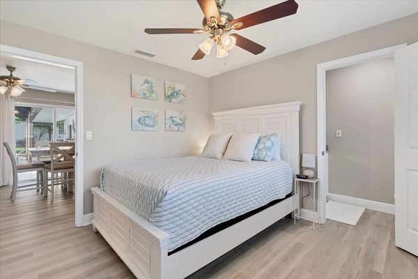 Guest bedroom 1 with queen bed and attached half bathroom
