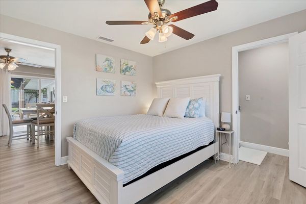 Guest bedroom 1 with queen bed and attached half bathroom