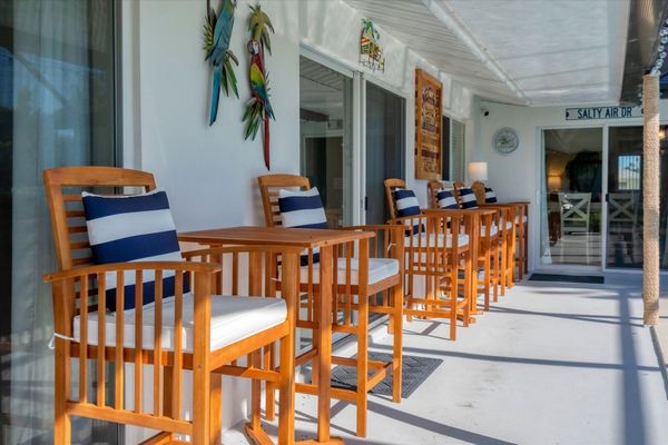 Relax and enjoy the view on the private lanai overlooking the sparkling pool and canal beyond