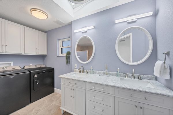 Primary attached bathroom with walk-in shower and double vanities