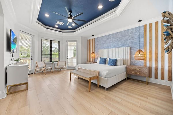 Escape to the vibrant master bedroom, a spacious retreat adorned with colorful decor and comfortable furnishings