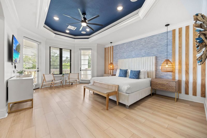 Escape to the vibrant master bedroom, a spacious retreat adorned with colorful decor and comfortable furnishings
