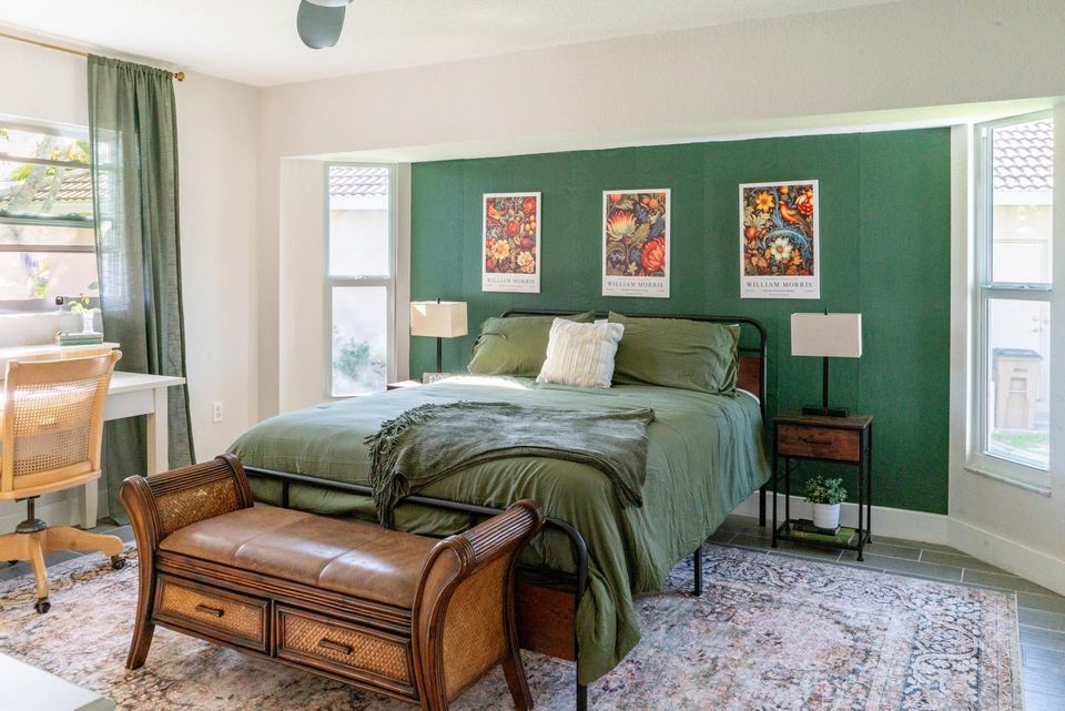 Primary bedroom featuring a queen bed and attached bathroom