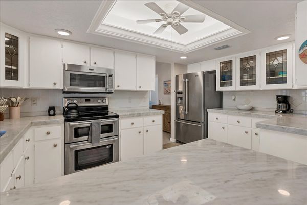 Bright, fully-equipped kitchen with plenty of countertop space and new stainless-steel appliances