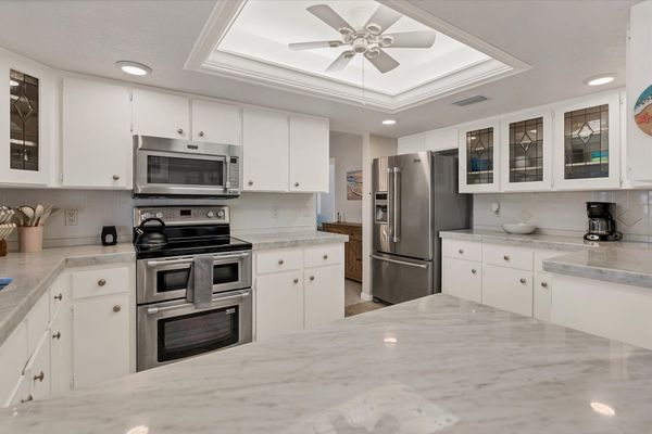 Bright, fully-equipped kitchen with plenty of countertop space and new stainless-steel appliances