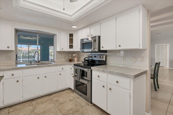 Bright, fully-equipped kitchen with plenty of countertop space and new stainless-steel appliances