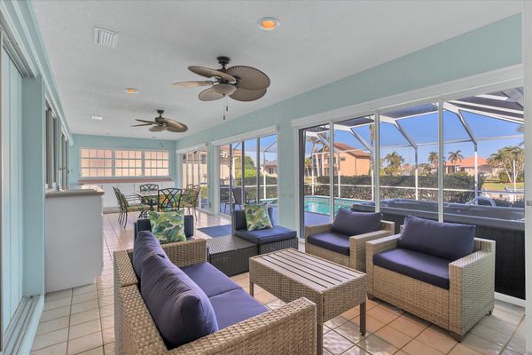 Spacious Florida room overlooking the pool. Florida room features with ample seating, mini fridge, and a dining table that seats 6