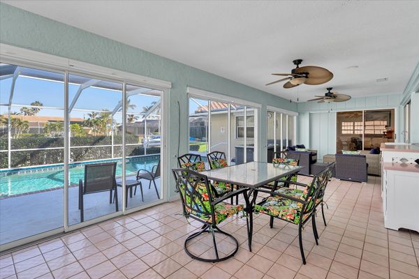 Spacious Florida room overlooking the pool. Florida room features with ample seating, mini fridge, and a dining table that seats 6