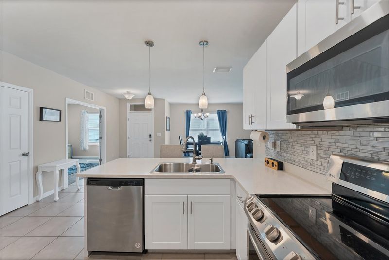 Fully-equipped kitchen overlooking the dining room and living room