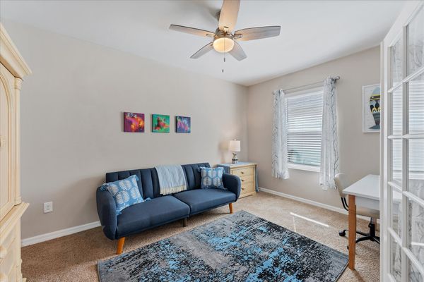 Den with twin futon, desk & chair, and Smart TV