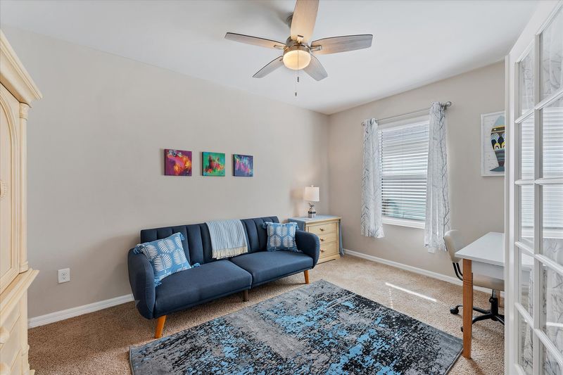 Den with twin futon, desk & chair, and Smart TV