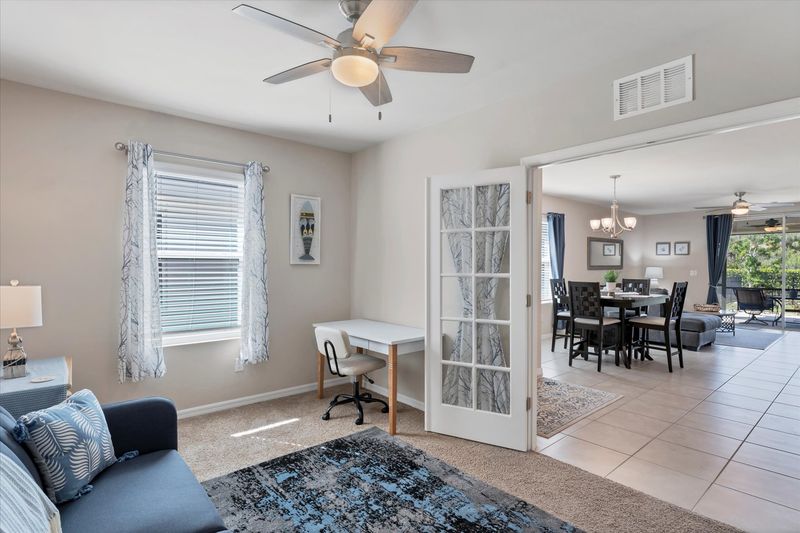 Den with twin futon, desk & chair, and Smart TV